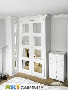 L-shape wardrobe with mirrored doors.