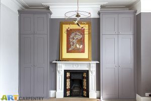 Alcove fitted wardrobes besides the chimney