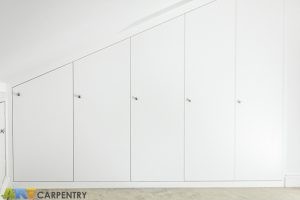 Contemporary MDF sloping wardrobe fitted in the loft spare room