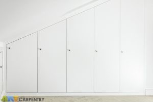 Contemporary MDF sloping wardrobe fitted in the loft spare room