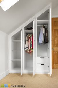 Contemporary MDF sloping wardrobe fitted in the loft spare room.