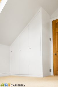 Contemporary MDF sloping wardrobe fitted in the loft spare room.